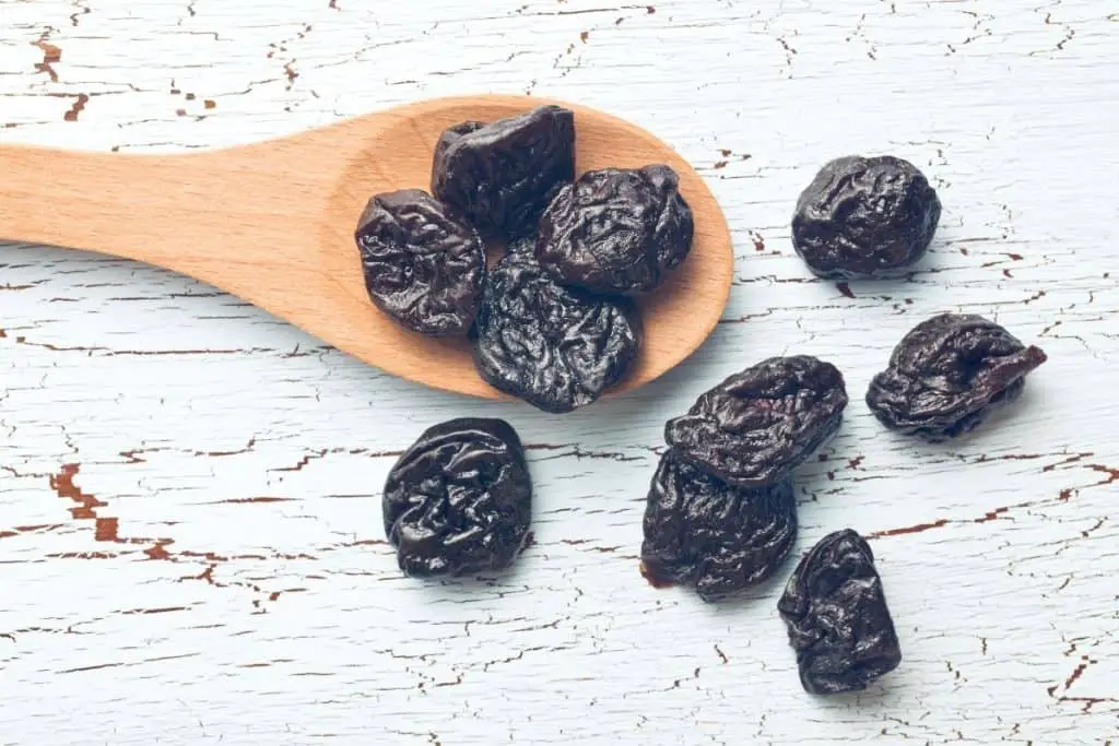 Prunes and a wooden spoon
